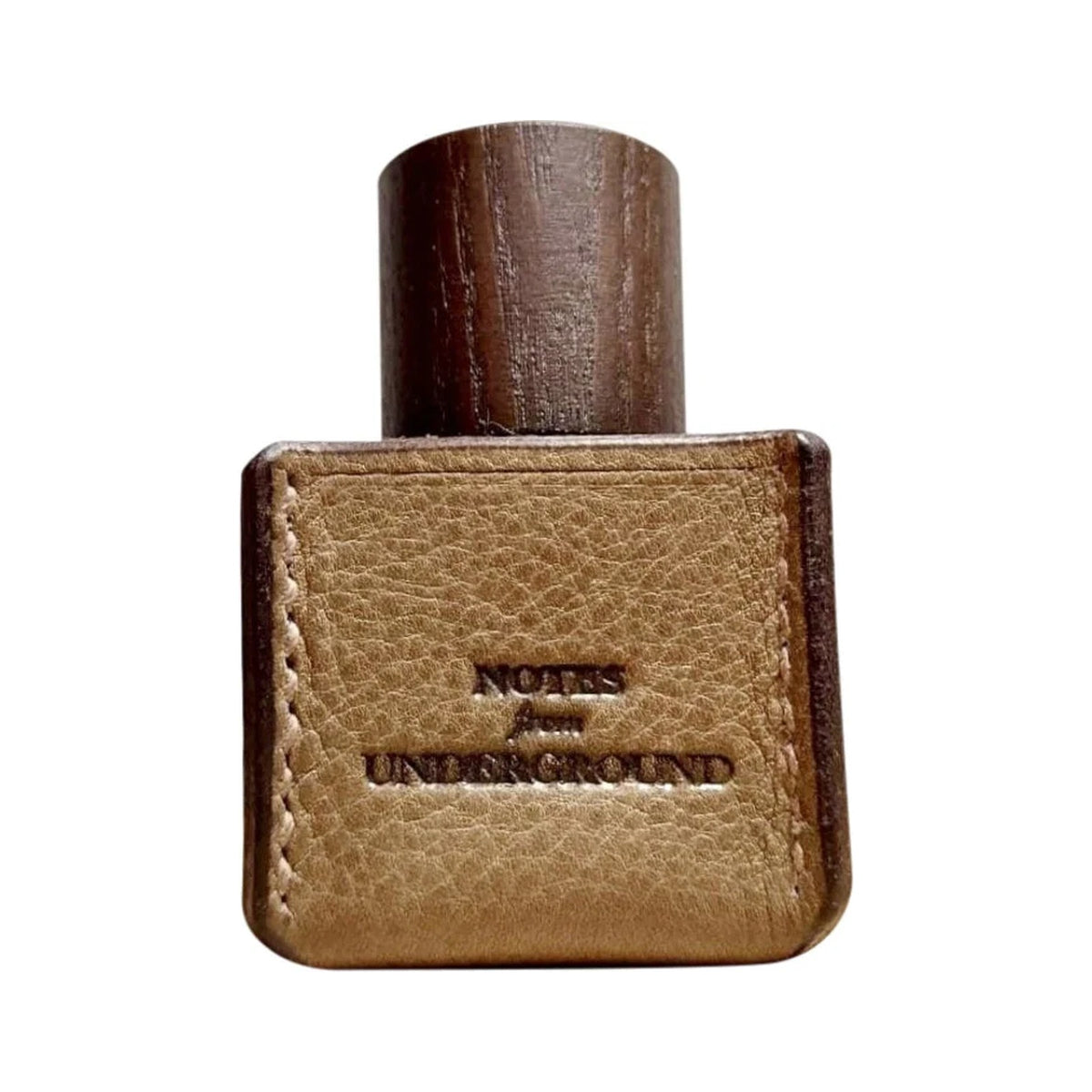 Notes from Underground by Ensar Oud, a square bottle in stitched tan leather embossed with its name, under a tall dark wooden cap