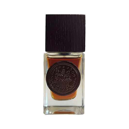 Kaavu by Chera People, a clear square flask of amber juice with a dark wooden cap and a round embossed medallion