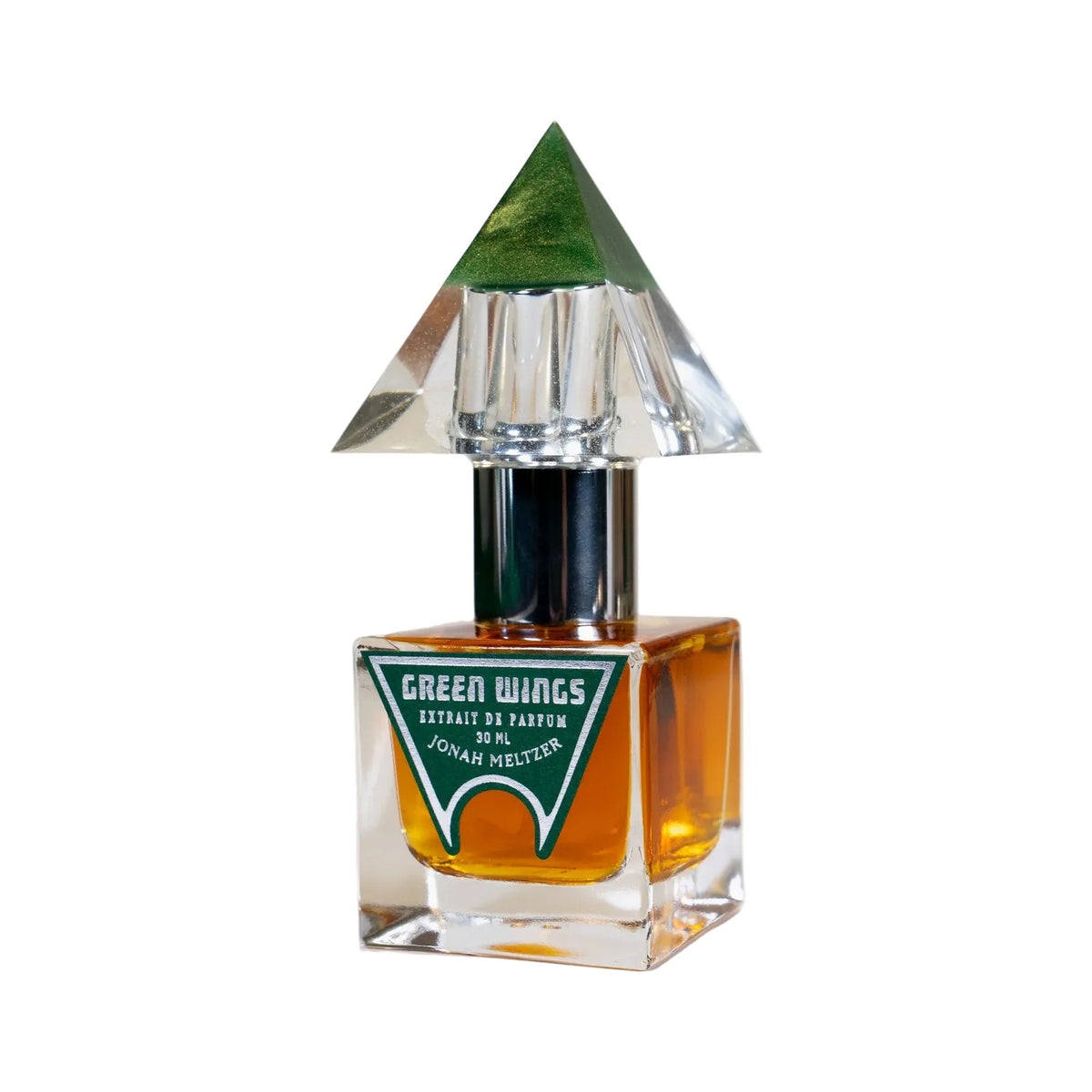 Green Wings by Jonah Meltzer, a square bottle of amber extrait with a green arched label, under a hand-cast resin cap shaped like a green-tipped pyramid