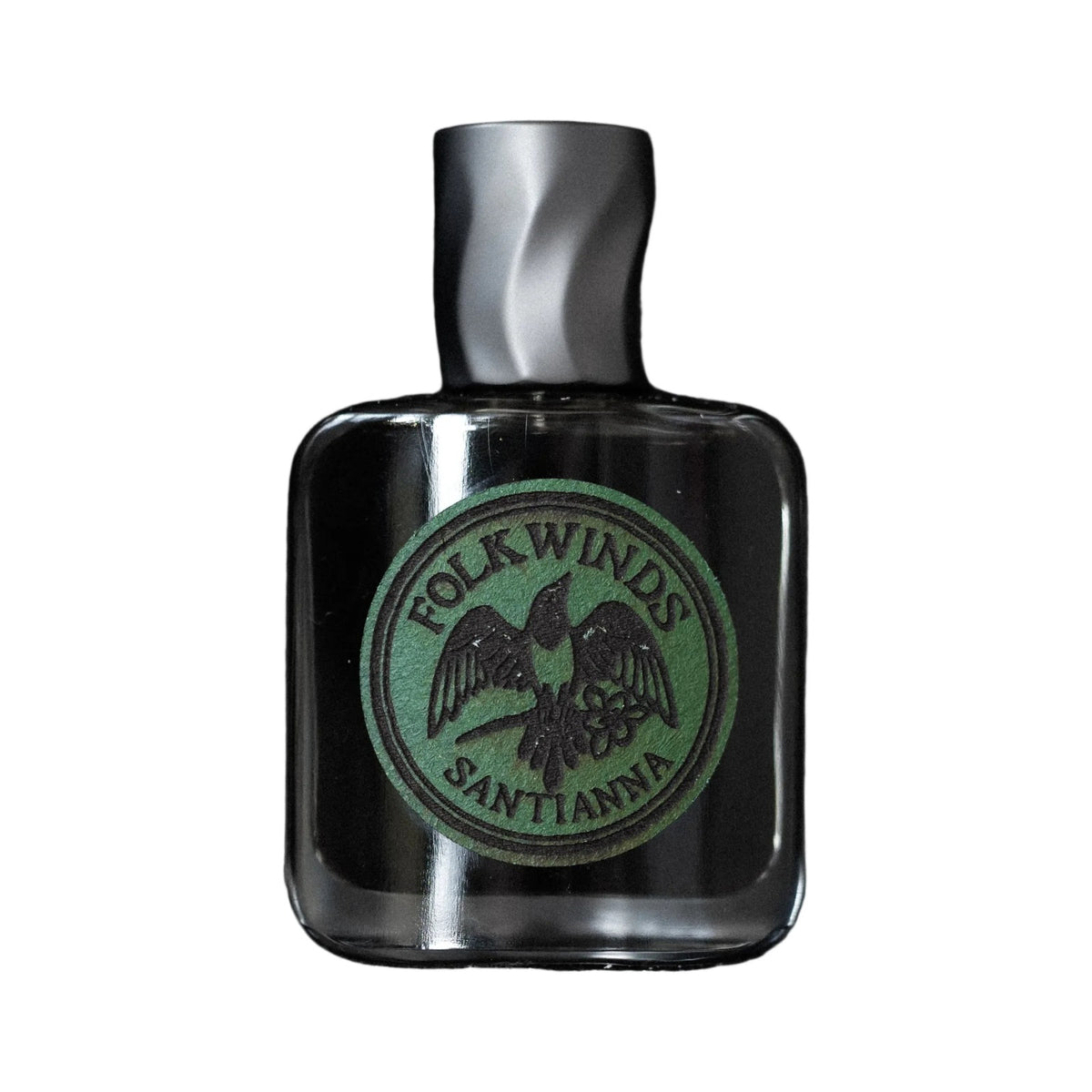 Santianna by Folkwinds, a square glass bottle with a round green Folkwinds label and a twisted brushed silver cap